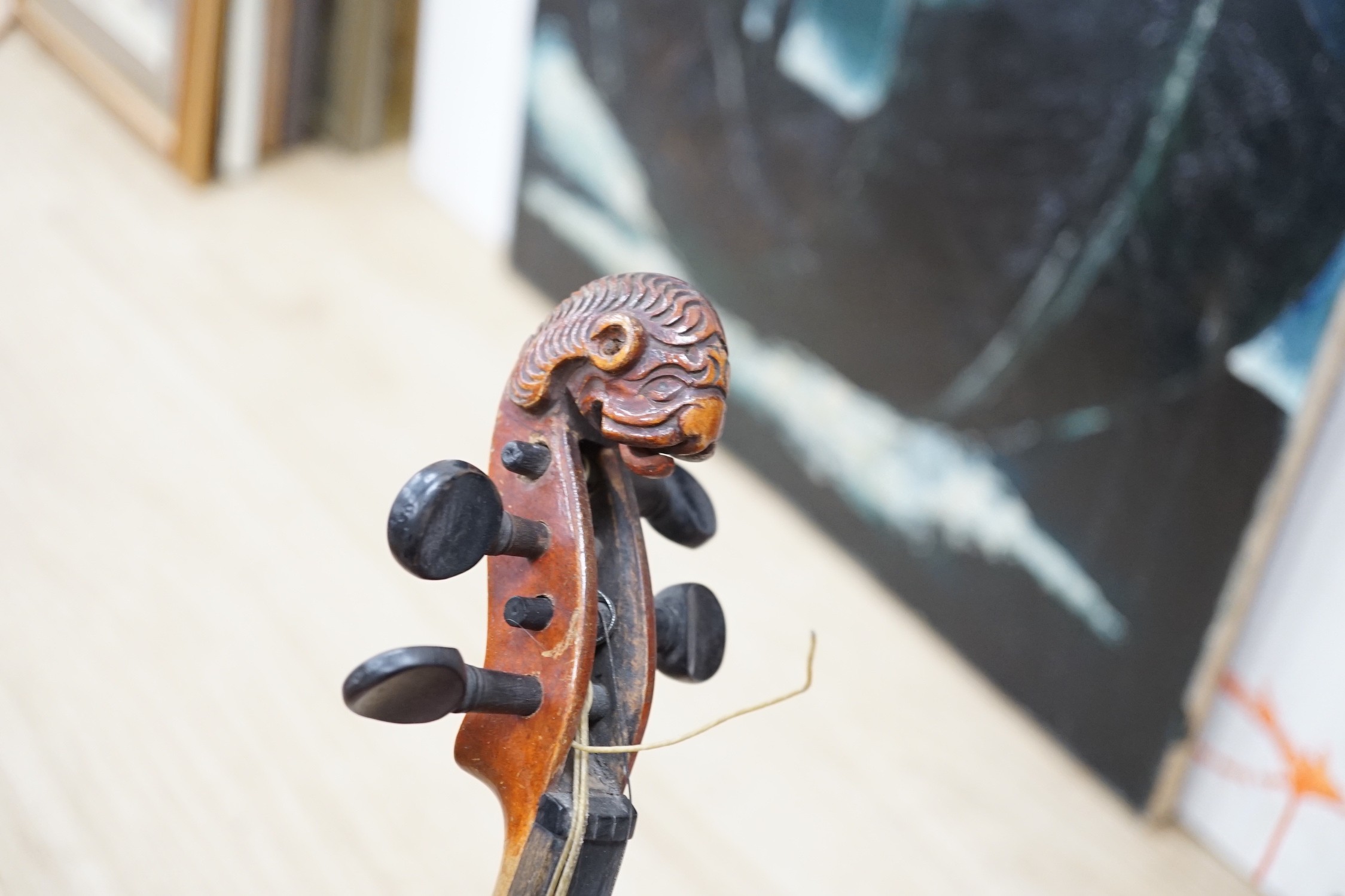 A late 19th century lion head violin and case